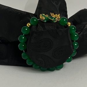 Beaded bracelet with green and gold tone dragon